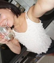 Tattooed beauty taking naked selfies in the kitchen