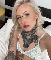 Tattooed blonde taking pictures of her small boobs