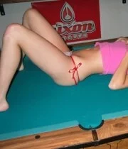 Cute blonde girlfriend lays on the pool table for some teasing