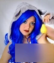 Blue haired cutie eats a pear and shows her tits
