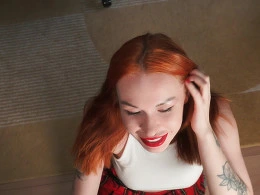 Redhead babe in a plain skirt sucks a cock in POV